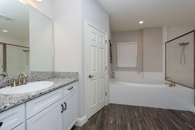 bathroom featuring wood-type flooring, vanity, and independent shower and bath