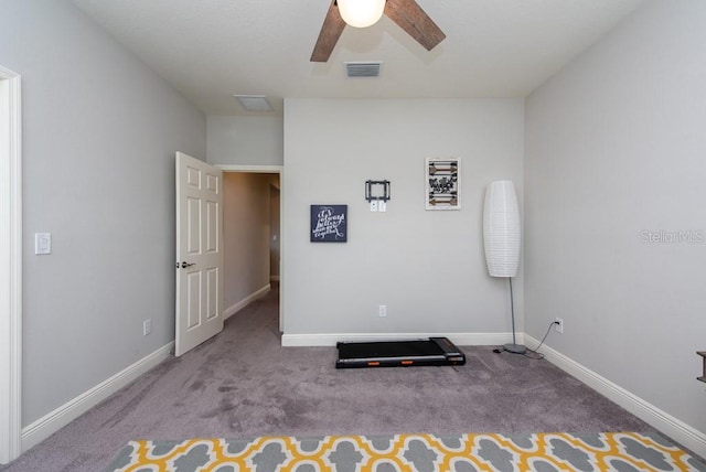 workout area with light carpet and ceiling fan