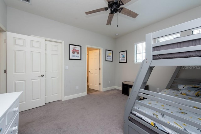 bedroom with light carpet, a closet, and ceiling fan