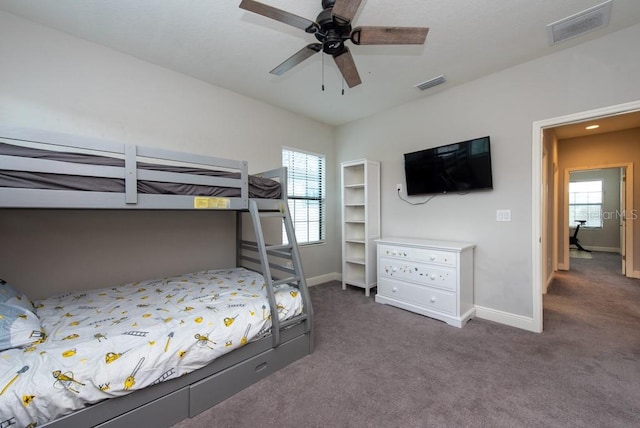 carpeted bedroom featuring ceiling fan and multiple windows