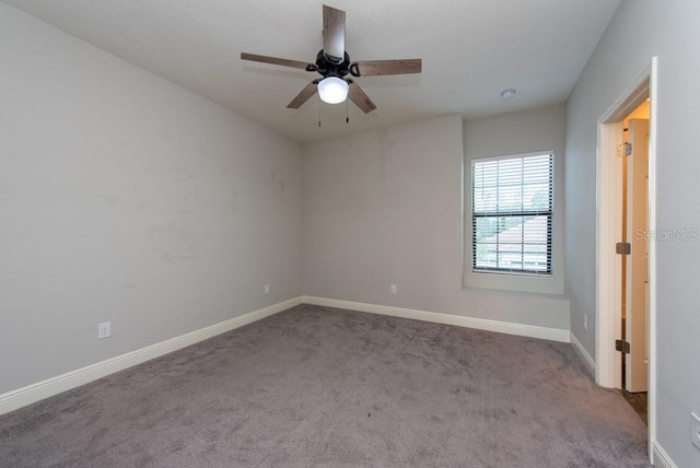 empty room with light colored carpet and ceiling fan