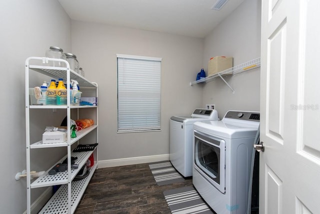 laundry area featuring dark hardwood / wood-style flooring and washing machine and dryer