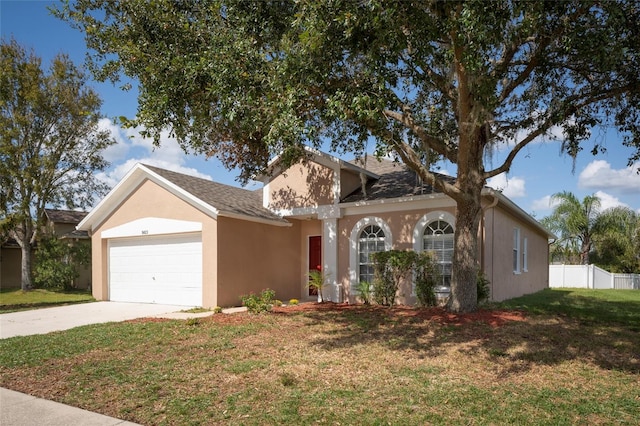 single story home featuring a front yard and a garage