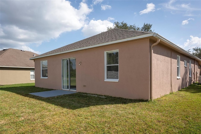 rear view of house featuring a yard