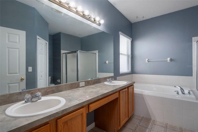 full bathroom featuring vanity, toilet, and independent shower and bath