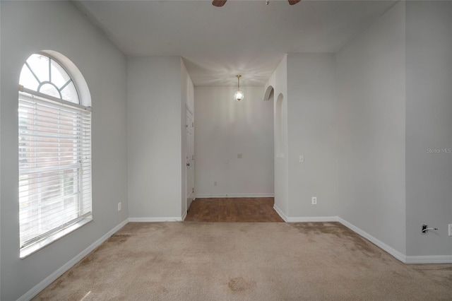 spare room with light colored carpet and ceiling fan