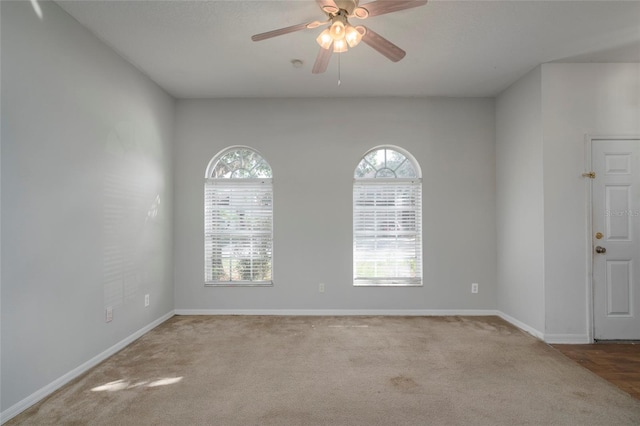 spare room featuring light carpet and ceiling fan