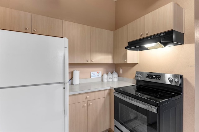 kitchen featuring light brown cabinets, white refrigerator, and stainless steel electric range