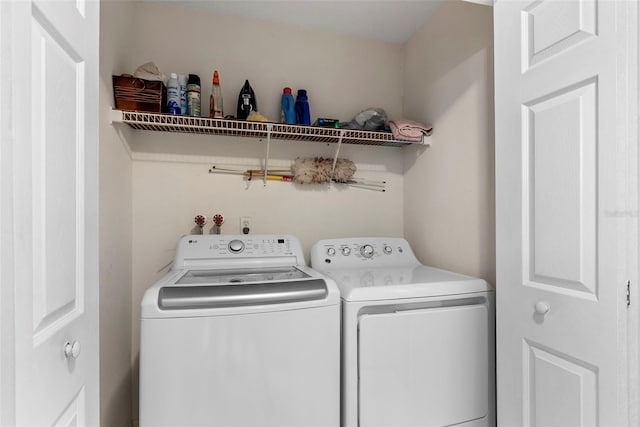 clothes washing area featuring washer and dryer