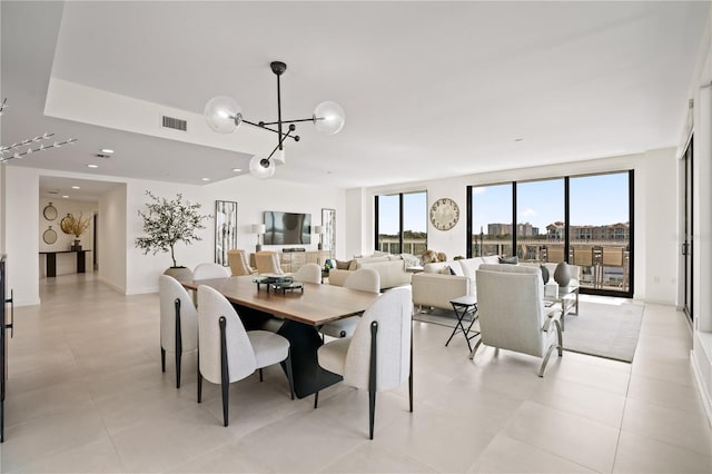 dining room with a notable chandelier and light tile patterned floors