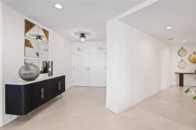 hall featuring light tile patterned flooring