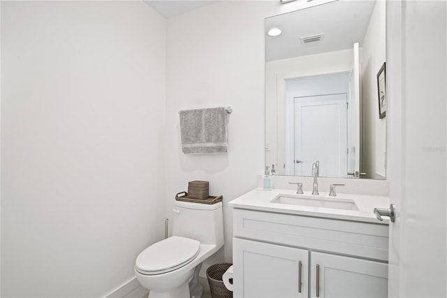 bathroom featuring toilet and vanity