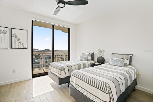 bedroom with access to exterior, light wood-type flooring, and ceiling fan