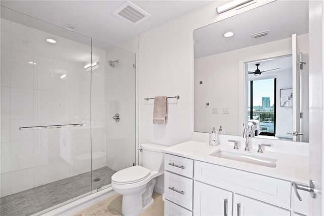 bathroom featuring toilet, tile patterned flooring, walk in shower, vanity, and ceiling fan