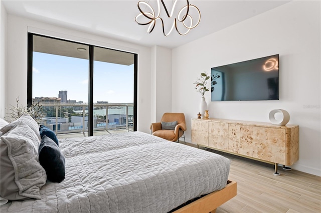 bedroom with access to outside and light wood-type flooring