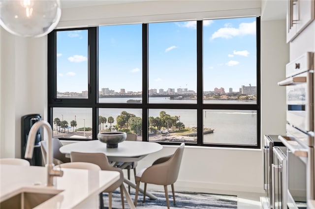 dining area with sink and a water view