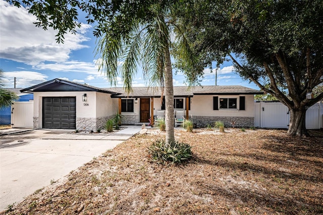 ranch-style home featuring a garage and covered porch