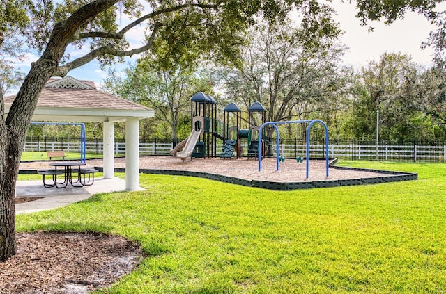 community playground featuring a yard, fence, and a gazebo