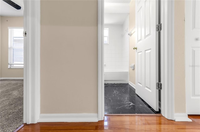 hallway featuring baseboards