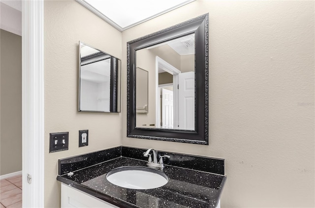 bathroom featuring tile patterned flooring and vanity