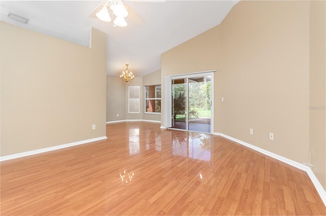 unfurnished room featuring high vaulted ceiling, visible vents, light wood-style flooring, and baseboards