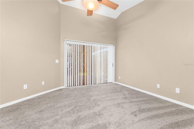 empty room featuring high vaulted ceiling, ceiling fan, baseboards, and carpet flooring