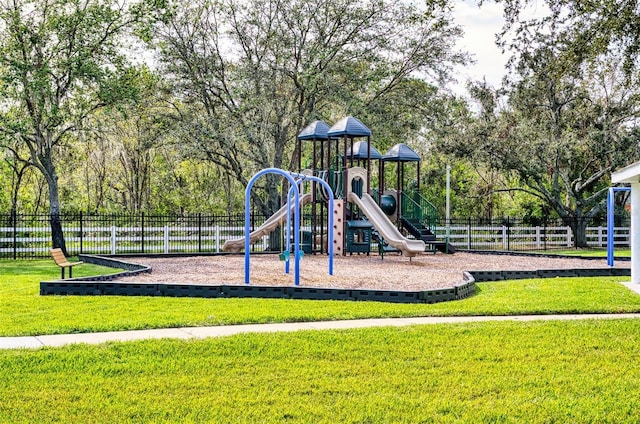 communal playground with fence and a lawn