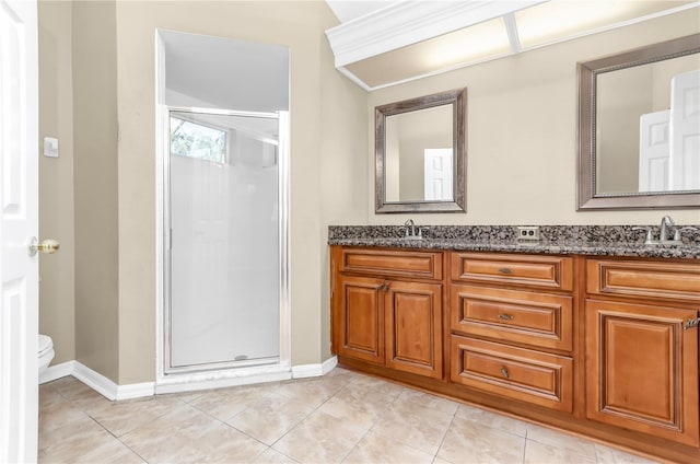 full bath with a sink, double vanity, baseboards, and a shower stall