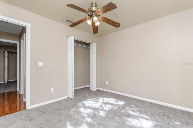 unfurnished bedroom featuring carpet flooring, baseboards, a closet, and visible vents