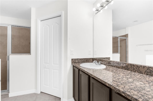 bathroom with tile patterned flooring, vanity, and an enclosed shower