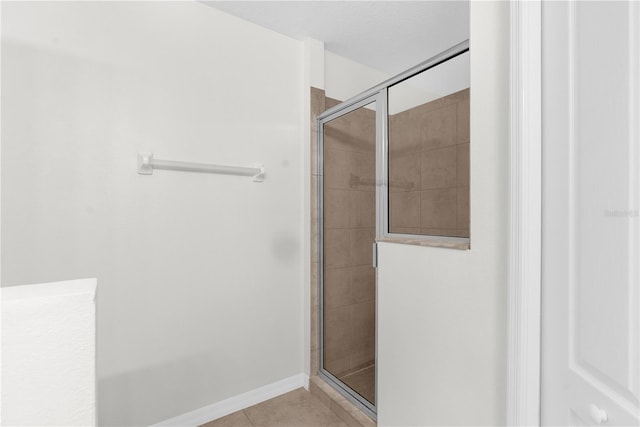 bathroom featuring tile patterned flooring and a shower with door