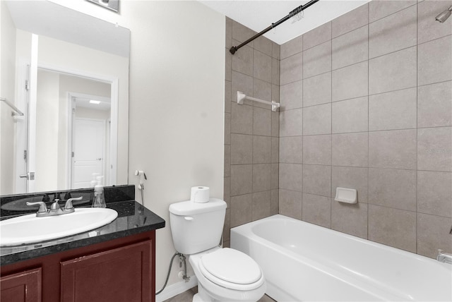 full bathroom featuring toilet, vanity, and tiled shower / bath combo