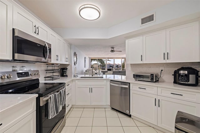 kitchen with white cabinetry, sink, ceiling fan, and stainless steel appliances