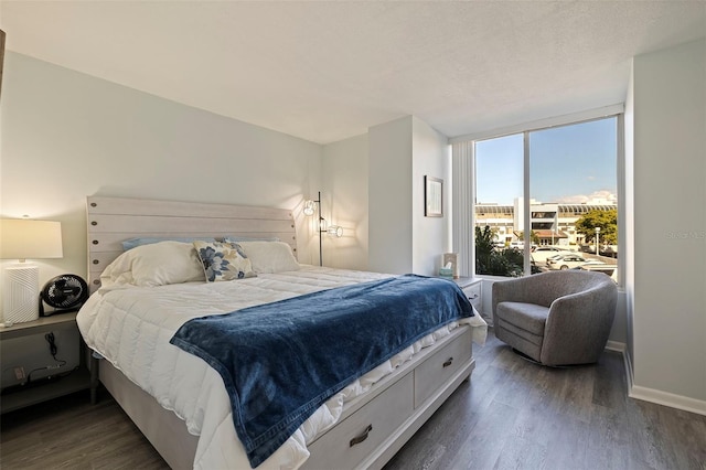 bedroom featuring a textured ceiling and dark hardwood / wood-style floors