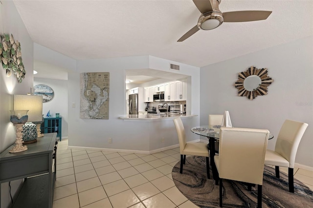 dining area featuring light tile patterned floors and ceiling fan