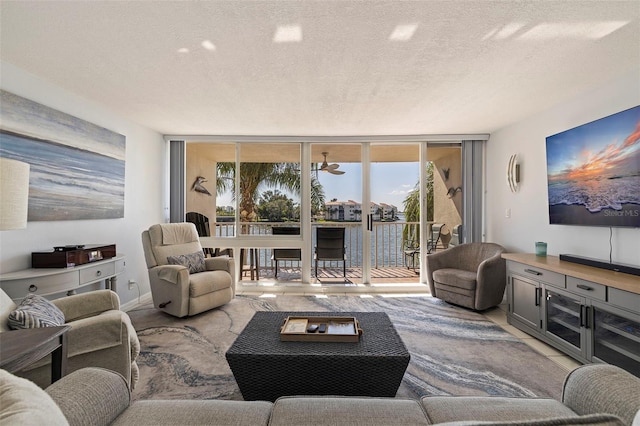 living room featuring expansive windows and a textured ceiling