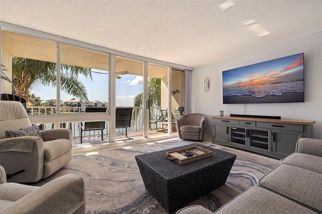 living room with expansive windows, a textured ceiling, and plenty of natural light