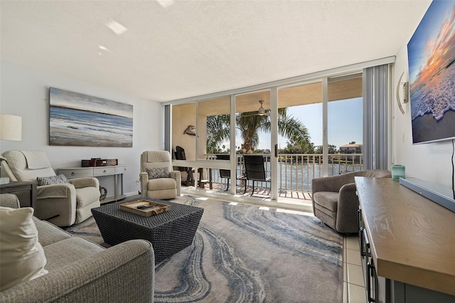 living room featuring expansive windows and a textured ceiling