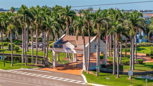 view of home's community with a yard and a water view