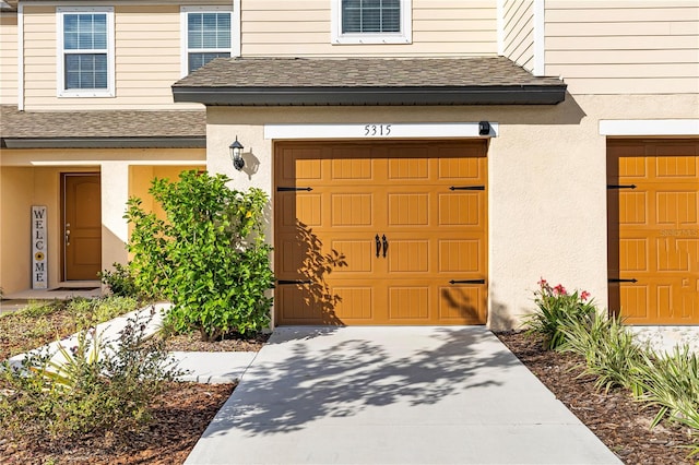 doorway to property with a garage