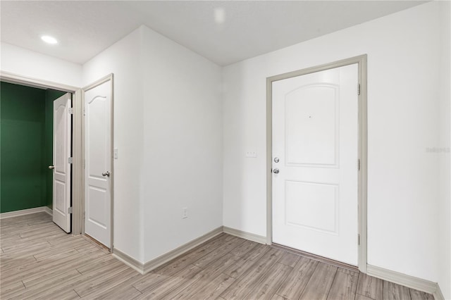 foyer entrance with light hardwood / wood-style flooring