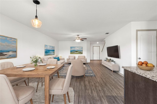 dining area with ceiling fan and dark hardwood / wood-style floors