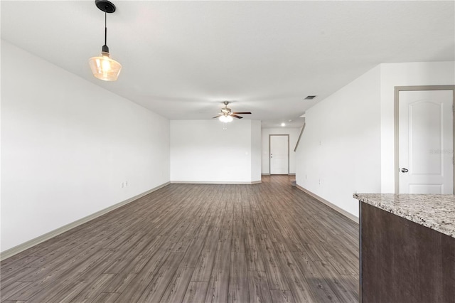 unfurnished living room with dark hardwood / wood-style floors and ceiling fan