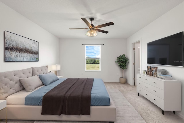 bedroom with light colored carpet and ceiling fan