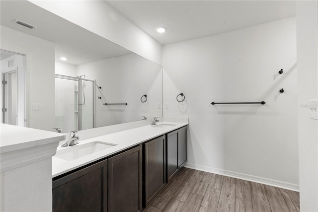 bathroom with vanity, wood-type flooring, and a shower with shower door