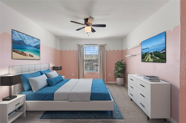 carpeted bedroom with ceiling fan and a textured ceiling