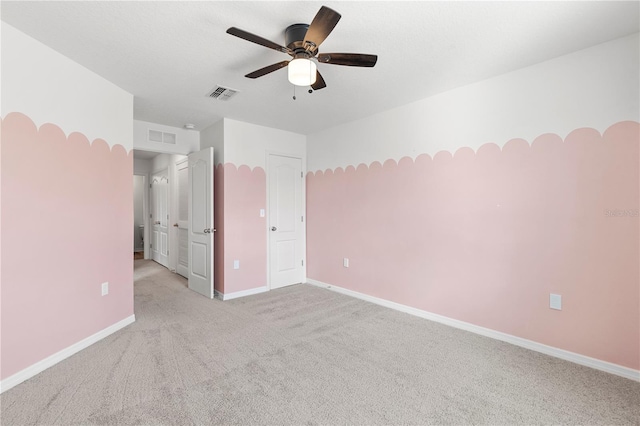 unfurnished bedroom featuring light carpet and ceiling fan