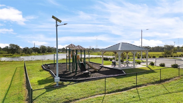 view of playground with a water view, a lawn, and a gazebo