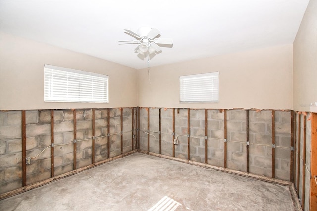 basement featuring ceiling fan and light carpet