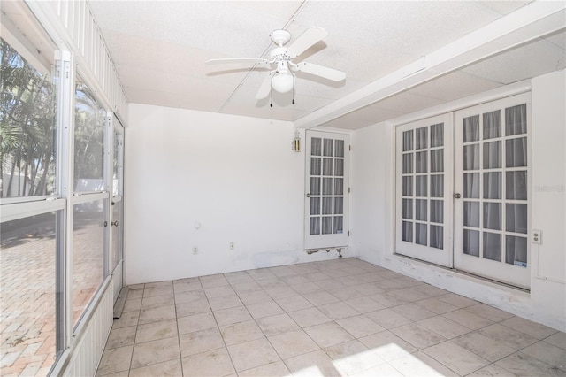 unfurnished sunroom featuring french doors and ceiling fan